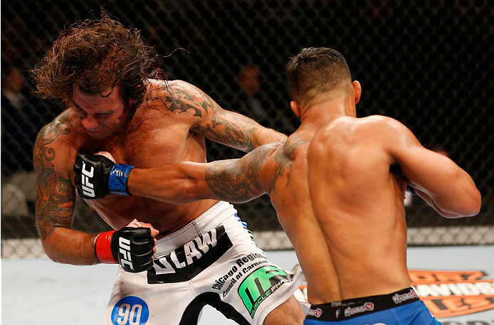 SAN JOSE, CA - JULY 26: (R-L) Dennis Bermudez punches Clay Guida in their featherweight bout during the UFC Fight Night event at SAP Center on July 26, 2014 in San Jose, California. (Photo by Josh Hedges/Zuffa LLC/Zuffa LLC via Getty Images)