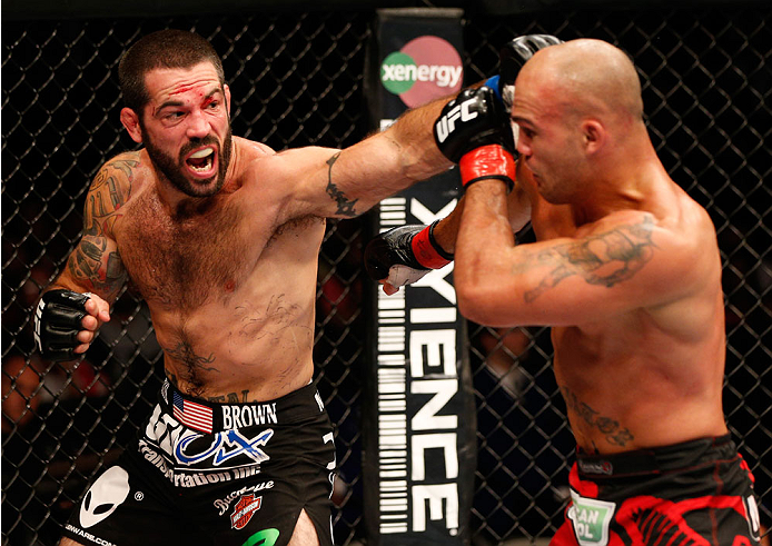 SAN JOSE, CA - JULY 26:  (L-R) Matt Brown punches Robbie Lawler in their welterweight bout during the UFC Fight Night event at SAP Center on July 26, 2014 in San Jose, California.  (Photo by Josh Hedges/Zuffa LLC/Zuffa LLC via Getty Images)