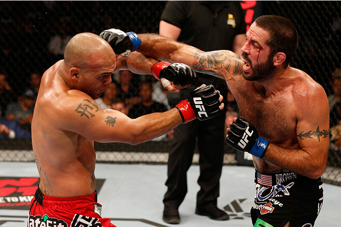 SAN JOSE, CA - JULY 26:  (R-L) Matt Brown punches Robbie Lawler in their welterweight bout during the UFC Fight Night event at SAP Center on July 26, 2014 in San Jose, California.  (Photo by Josh Hedges/Zuffa LLC/Zuffa LLC via Getty Images)