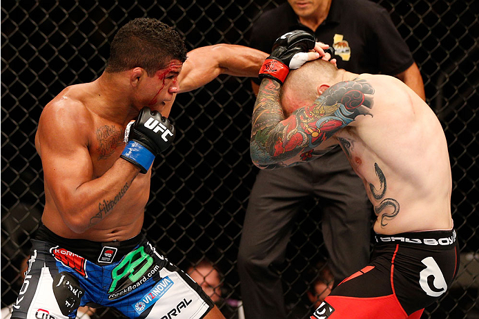 SAN JOSE, CA - JULY 26:  (L-R) Gilbert Burns punches Andreas Stahl in their welterweight bout during the UFC Fight Night event at SAP Center on July 26, 2014 in San Jose, California.  (Photo by Josh Hedges/Zuffa LLC/Zuffa LLC via Getty Images)