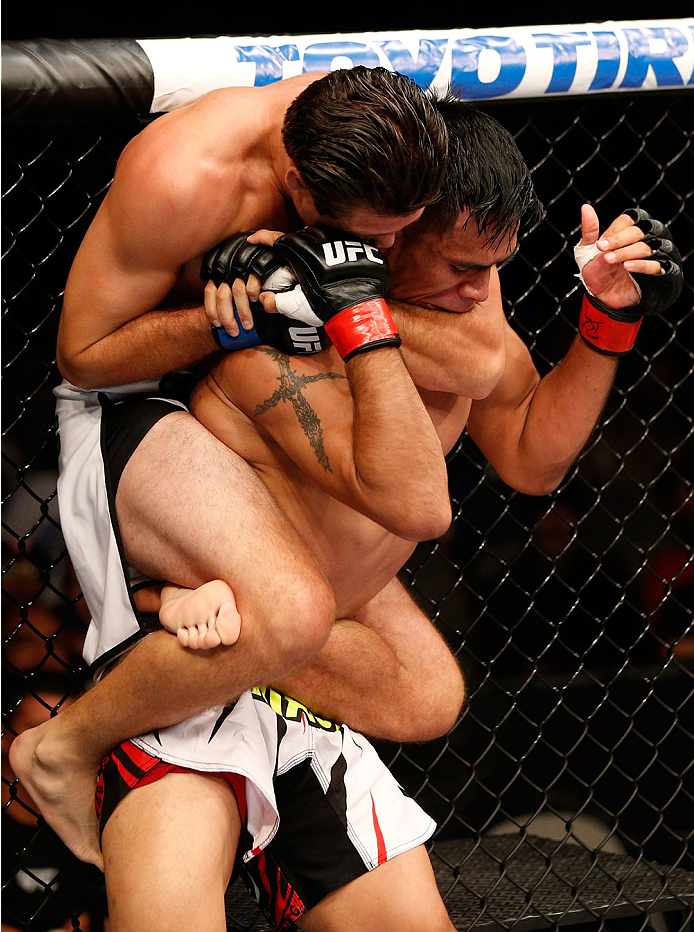 SAN JOSE, CA - JULY 26:  (L-R) Brian Ortega attempts to secure a rear choke submission against Mike De La Torre in their featherweight bout during the UFC Fight Night event at SAP Center on July 26, 2014 in San Jose, California.  (Photo by Josh Hedges/Zuf