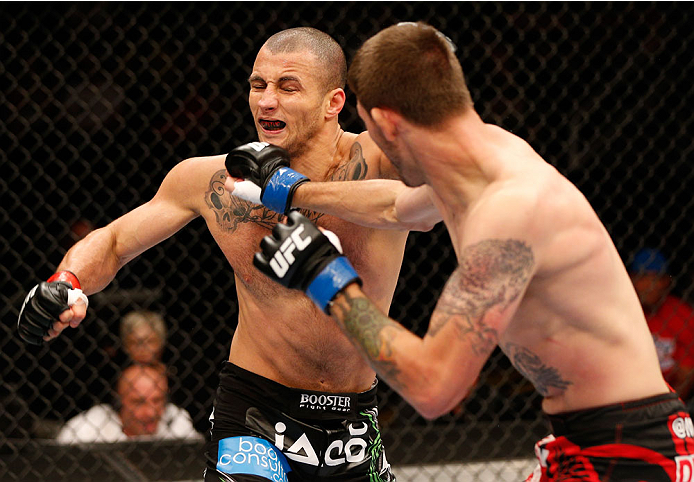 SAN JOSE, CA - JULY 26:  (R-L) Tim Means punches Hernani Perpetuo in their welterweight bout during the UFC Fight Night event at SAP Center on July 26, 2014 in San Jose, California.  (Photo by Josh Hedges/Zuffa LLC/Zuffa LLC via Getty Images)