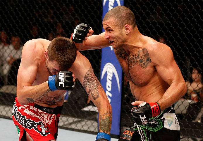 SAN JOSE, CA - JULY 26:  (R-L) Hernani Perpetuo punches Tim Means in their welterweight bout during the UFC Fight Night event at SAP Center on July 26, 2014 in San Jose, California.  (Photo by Josh Hedges/Zuffa LLC/Zuffa LLC via Getty Images)