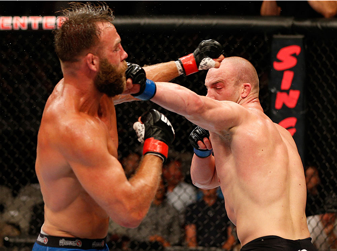 SAN JOSE, CA - JULY 26:  (R-L) Patrick Cummins punches Kyle Kingsbury in their light heavyweight bout during the UFC Fight Night event at SAP Center on July 26, 2014 in San Jose, California.  (Photo by Josh Hedges/Zuffa LLC/Zuffa LLC via Getty Images)