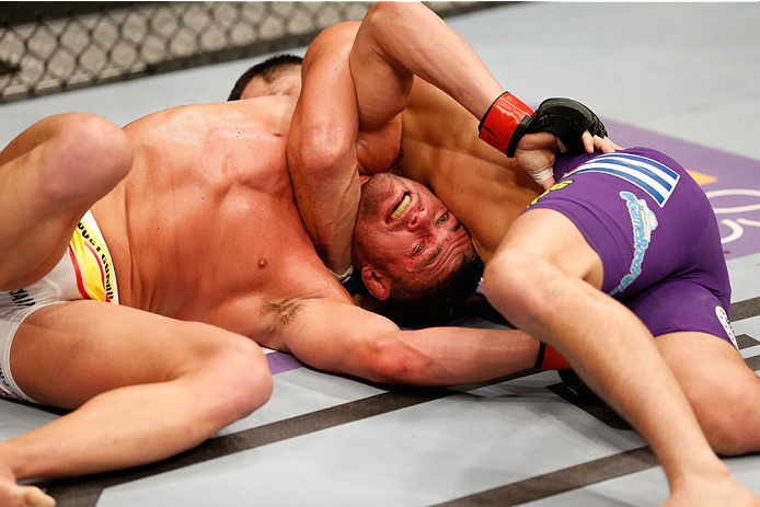 SAN JOSE, CA - JULY 26: (R-L) Jorge Masvidal attempts to secure a darce choke against Daron Cruickshank in their lightweight bout during the UFC Fight Night event at SAP Center on July 26, 2014 in San Jose, California. (Photo by Josh Hedges/Zuffa LLC/Zu