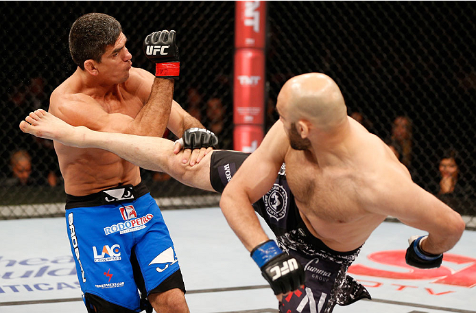 SAO PAULO, BRAZIL - MAY 31:  (R-L) Gasan Umalatov kicks Paulo Thiago in their welterweight fight during the UFC Fight Night event at the Ginasio do Ibirapuera on May 31, 2014 in Sao Paulo, Brazil. (Photo by Josh Hedges/Zuffa LLC/Zuffa LLC via Getty Images