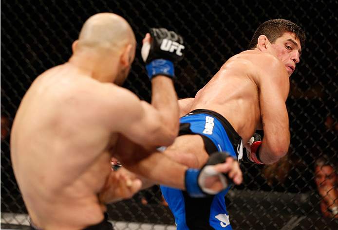 SAO PAULO, BRAZIL - MAY 31:  (R-L) Paulo Thiago kicks Gasan Umalatov in their welterweight fight during the UFC Fight Night event at the Ginasio do Ibirapuera on May 31, 2014 in Sao Paulo, Brazil. (Photo by Josh Hedges/Zuffa LLC/Zuffa LLC via Getty Images