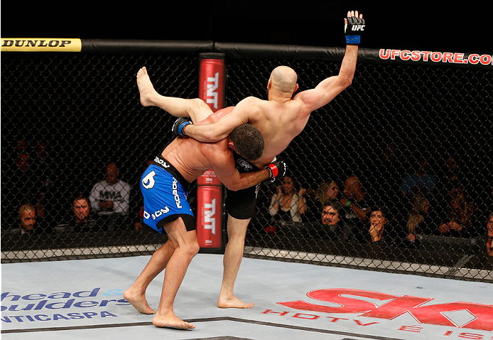 SAO PAULO, BRAZIL - MAY 31: (L-R) Paulo Thiago takes down Gasan Umalatov in their welterweight fight during the UFC Fight Night event at the Ginasio do Ibirapuera on May 31, 2014 in Sao Paulo, Brazil. (Photo by Josh Hedges/Zuffa LLC/Zuffa LLC via Getty I