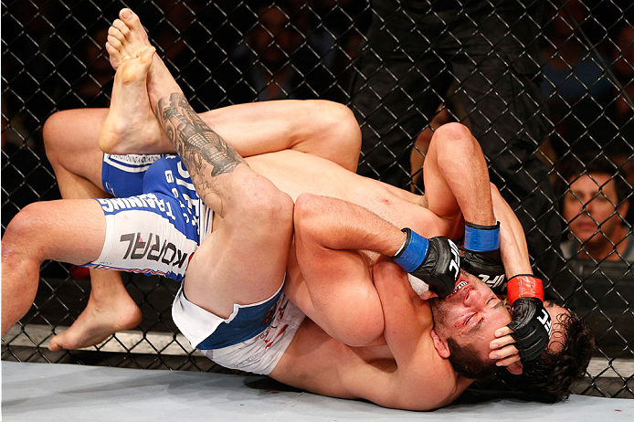 SAO PAULO, BRAZIL - MAY 31: (R-L) Elias Silverio secures a rear choke submission against Ernest Chavez in their lightweight fight during the UFC Fight Night event at the Ginasio do Ibirapuera on May 31, 2014 in Sao Paulo, Brazil. (Photo by Josh Hedges/Zuf