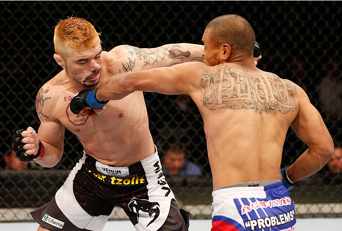 SAO PAULO, BRAZIL - MAY 31: (L-R) Rony "Jason" Mariano-Bazzera and Robbie Peralta trade punches in their featherweight fight during the UFC Fight Night event at the Ginasio do Ibirapuera on May 31, 2014 in Sao Paulo, Brazil. (Photo by Josh Hedges/Zuffa LL