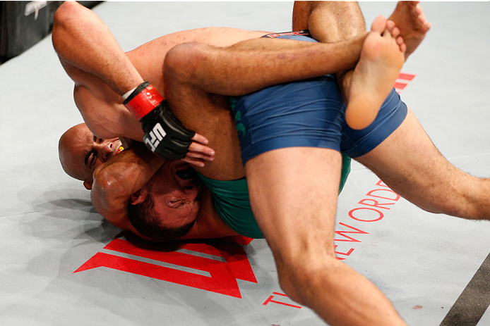 SAO PAULO, BRAZIL - MAY 31: (L-R) Warlley Alves secures a guillotine choke submission against Marcio Alexandre in their middleweight fight during the UFC Fight Night event at the Ginasio do Ibirapuera on May 31, 2014 in Sao Paulo, Brazil. (Photo by Josh