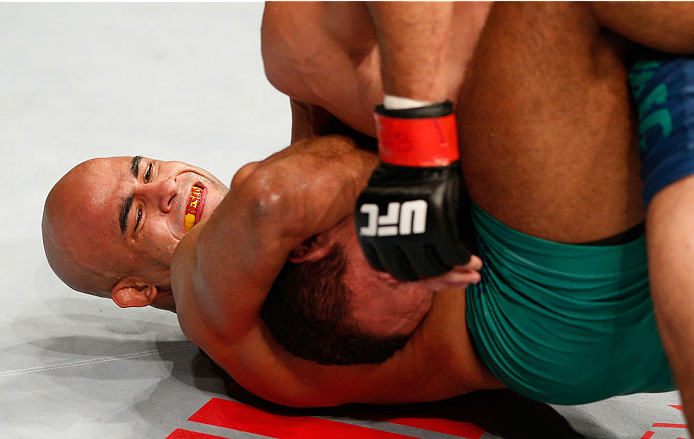 SAO PAULO, BRAZIL - MAY 31:  (L-R) Warlley Alves secures a guillotine choke submission against Marcio Alexandre in their middleweight fight during the UFC Fight Night event at the Ginasio do Ibirapuera on May 31, 2014 in Sao Paulo, Brazil. (Photo by Josh 