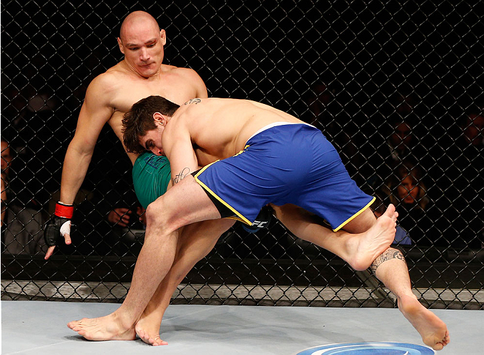 SAO PAULO, BRAZIL - MAY 31:  (R-L) Antonio Carlos Junior takes down Vitor Miranda in their heavyweight fight during the UFC Fight Night event at the Ginasio do Ibirapuera on May 31, 2014 in Sao Paulo, Brazil. (Photo by Josh Hedges/Zuffa LLC/Zuffa LLC via 