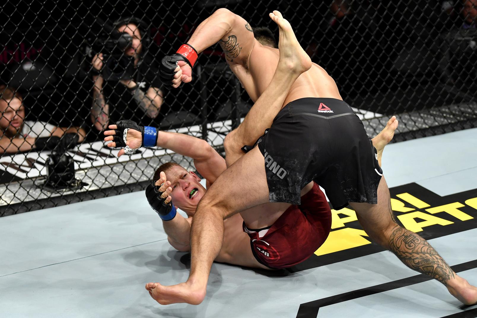 Punahele Soriano punches Oskar Piechota of Poland in their middleweight bout during the UFC 245.