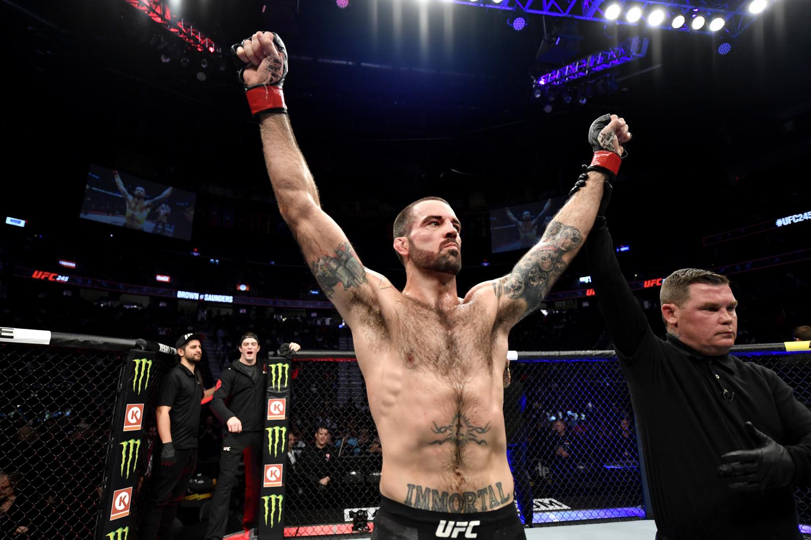 Matt Brown raises his hands in victory over Ben Saunders in their welterweight bout during the UFC 245.