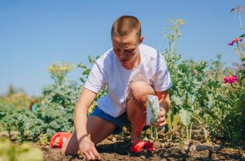 Rose Namajunas tends to her garden at Rose Roots Community Garden in Arvada, Colorado, on August 25, 2021. (Photo by Zac Pacleb)