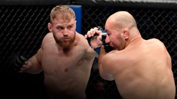 ABU DHABI, UNITED ARAB EMIRATES - OCTOBER 30: (L-R) Jan Blachowicz of Poland punches Glover Teixeira of Brazil in the UFC light heavyweight championship fight during the UFC 267 event at Etihad Arena on October 30, 2021 in Yas Island, Abu Dhabi, United Arab Emirates. (Photo by Chris Unger/Zuffa LLC)