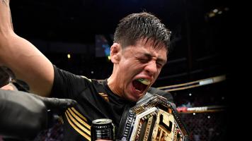 Brandon Moreno of Mexico reacts after submitting Deiveson Figueiredo of Brazil to win the UFC flyweight championship fight during the UFC 263 event at Gila River Arena on June 12 2021 in Glendale Arizona. (Photo by Jeff Bottari/Zuffa LLC)