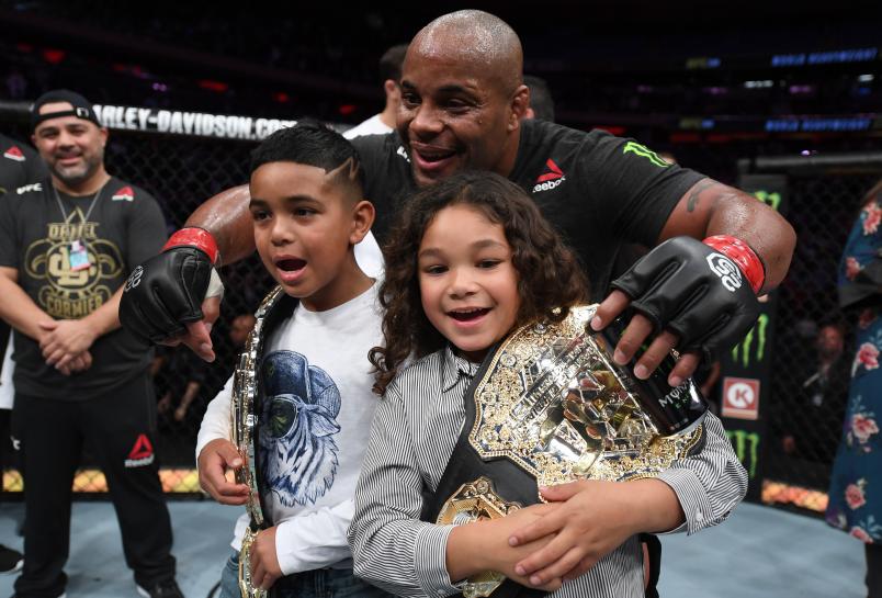 NEW YORK, NY - NOVEMBER 03:  Daniel Cormier celebrates with his kids after his submission victory over Derrick Lewis in their UFC heavyweight championship bout during the UFC 230 event inside Madison Square Garden on November 3, 2018 in New York, New York. (Photo by Jeff Bottari/Zuffa LLC)