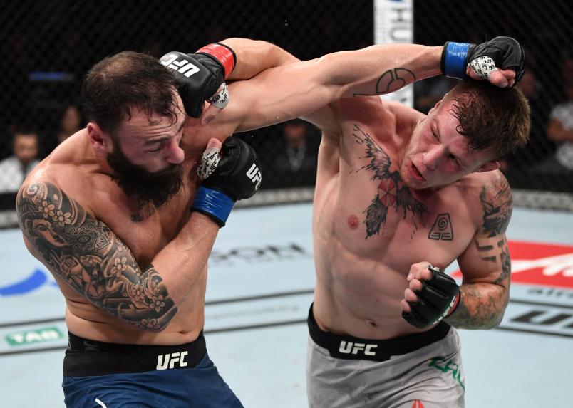 ADELAIDE, AUSTRALIA - DECEMBER 02: (R-L) Jimmy Crute of Australia punches Paul Craig of Scotland in their light heavyweight bout during the UFC Fight Night event inside Adelaide Entertainment Centre on December 2, 2018 in Adelaide, Australia. (Photo by Jeff Bottari/Zuffa LLC/Zuffa LLC via Getty Images)