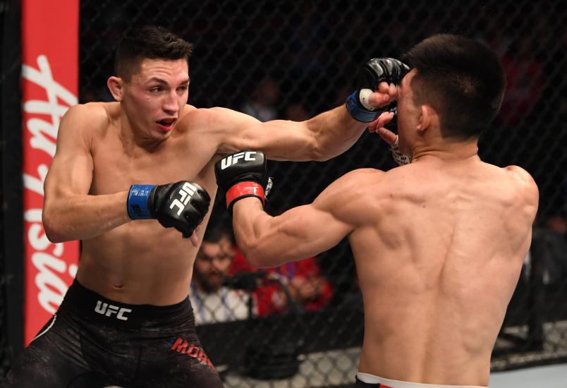 BEIJING, CHINA - NOVEMBER 24: (L-R) Vince Morales punches Song Yadong of China in their bantamweight bout during the UFC Fight Night event inside Cadillac Arena on November 24, 2018 in Beijing, China. (Photo by Jeff Bottari/Zuffa LLC/Zuffa LLC via Getty Images)