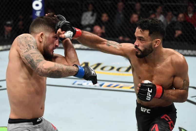 MILWAUKEE, WISCONSIN - DECEMBER 15: (R-L) Rob Font punches Sergio Pettis in their bantamweight bout during the UFC Fight Night event at Fiserv Forum on December 15, 2018 in Milwaukee, Wisconsin. (Photo by Jeff Bottari/Zuffa LLC/Zuffa LLC via Getty Images)