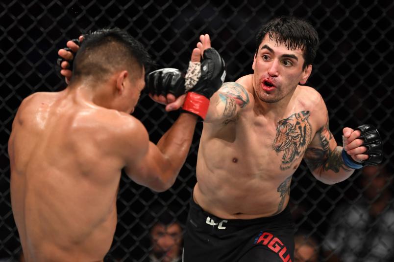 PHILADELPHIA, PA - MARCH 30: (R-L) Kevin Aguilar punches Enrique Barzola of Peru in their featherweight bout during the UFC Fight Night event at Wells Fargo Center on March 30, 2019 in Philadelphia, Pennsylvania. (Photo by Josh Hedges/Zuffa LLC/Zuffa LLC via Getty Images)
