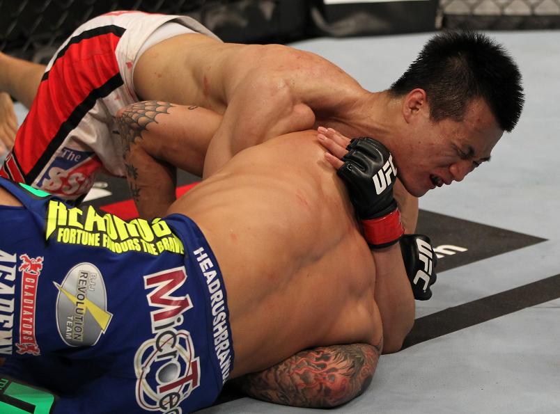 FAIRFAX, VA - MAY 15: (L-R) "The Korean Zombie" Chan Sung Jung defeats Dustin Poirier with a d'arce choke submission in a featherweight bout during the UFC on Fuel TV event at Patriot Center on May 15, 2012 in Fairfax, Virginia. (Photo by Josh Hedges/Zuffa LLC/Zuffa LLC via Getty Images)