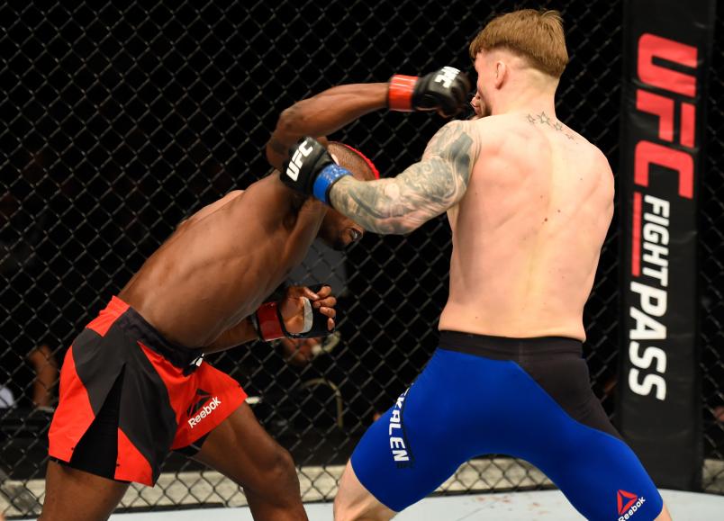 LONDON, ENGLAND - MARCH 18: (L-R) Marc Diakiese of the Congo punches Teemu Packalen of Finland in their lightweight fight during the UFC Fight Night event at The O2 arena on March 18, 2017 in London, England. (Photo by Josh Hedges/Zuffa LLC/Zuffa LLC via Getty Images)