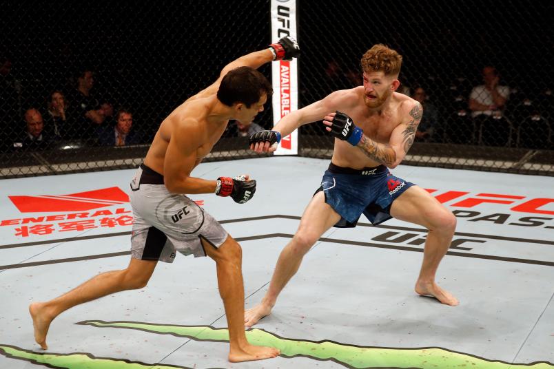 BUENOS AIRES, ARGENTINA - NOVEMBER 17: (L-R) Humberto Bandenay of Peru punches Austin Arnett in their featherweight bout during the UFC Fight Night event inside Arena Parque Roca in Buenos Aires, Argentina. (Photo by Alexandre Schneider/Zuffa LLC)