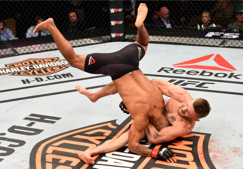 LAS VEGAS, NV - DECEMBER 03: (R-L) Timothy Elliott attempts to secure a guillotine choke submission against Demetrious Johnson in their flyweight championship bout during The Ultimate Fighter Finale event inside the Pearl concert theater at the Palms Resort & Casino on December 3, 2016 in Las Vegas, Nevada. (Photo by Jeff Bottari/Zuffa LLC/Zuffa LLC via Getty Images)
