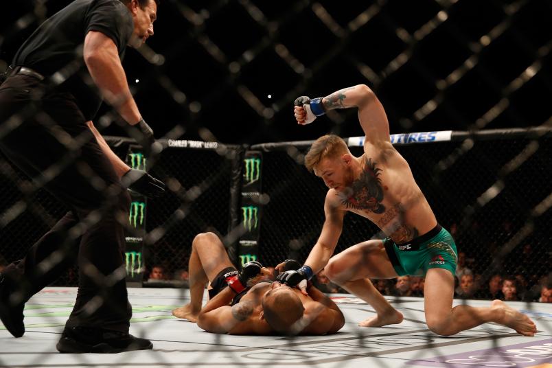 Conor McGregor of Ireland (top) punches Jose Aldo of Brazil in their UFC featherweight championship bout during the UFC 194 event inside MGM Grand Garden Arena on December 12, 2015 in Las Vegas, Nevada. (Photo by Christian Petersen/Zuffa LLC via Getty Images)