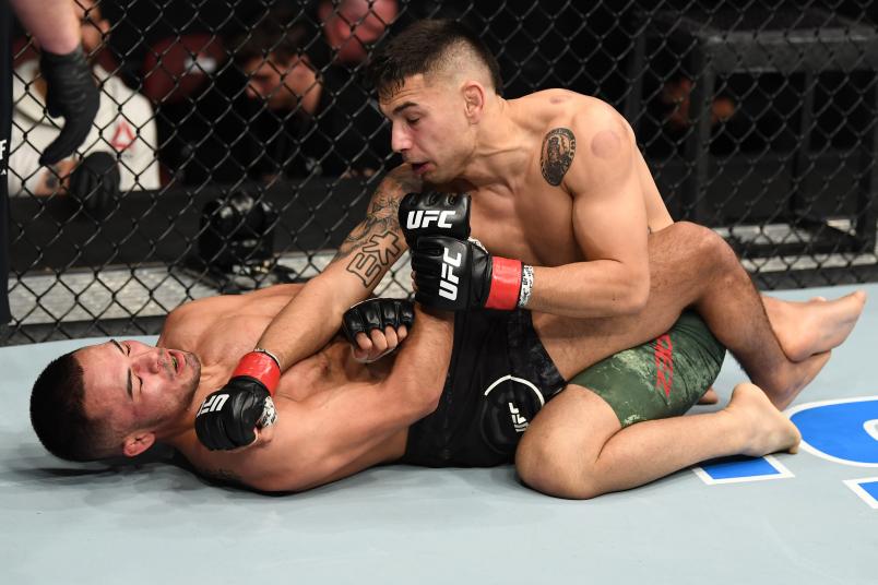 PHILADELPHIA, PA - MARCH 30: (R-L) Alex Perez punches Mark De La Rosa in their bantamweight bout during the UFC Fight Night event at Wells Fargo Center on March 30, 2019 in Philadelphia, Pennsylvania. (Photo by Josh Hedges/Zuffa LLC/Zuffa LLC via Getty Images)