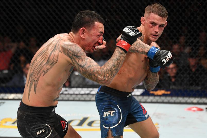 Dustin Poirier punches Max Holloway in their interim lightweight championship bout during the UFC 236 event at State Farm Arena on April 13, 2019 in Atlanta, Georgia. (Photo by Josh Hedges/Zuffa LLC via Getty Images)