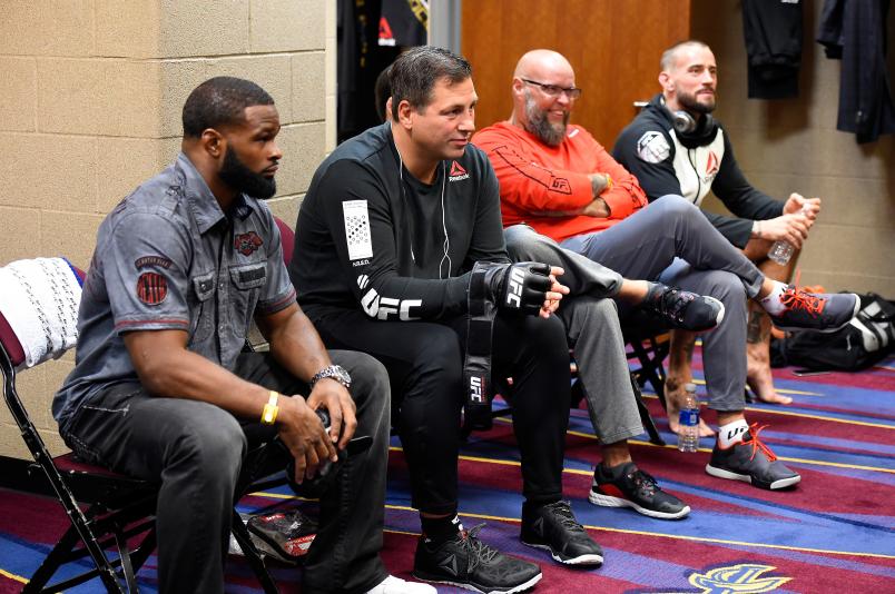Tyron Woodley, coach/trainer Duke Roufus and Phil 'CM Punk' Brooks rest backstage during the UFC 203 event at Quicken Loans Arena on September 10, 2016 in Cleveland, Ohio. (Photo by Mike Roach/Zuffa LLC via Getty Images)