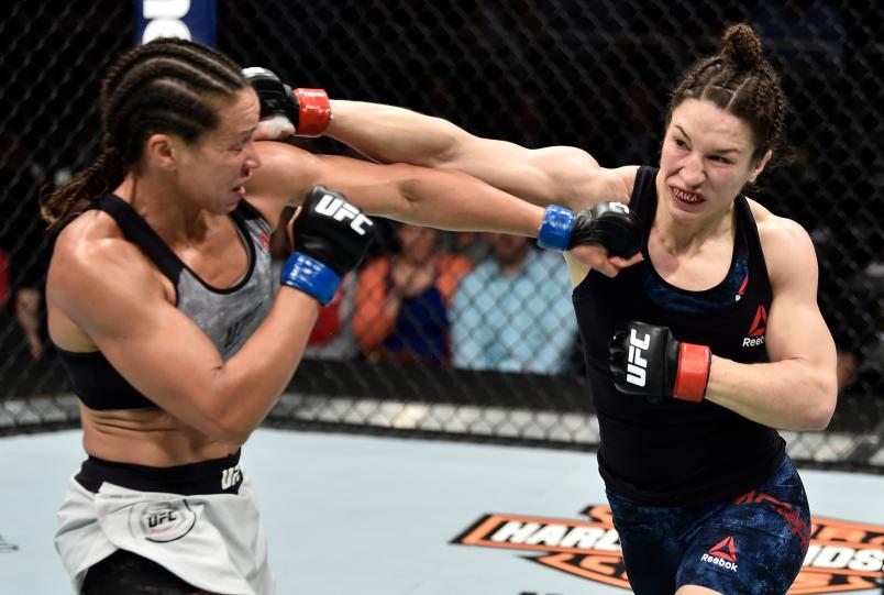 ORLANDO, FL - FEBRUARY 24: (R-L) Sara McMann and Marion Reneau trade punches in their women's bantamweight bout during the UFC Fight Night event at Amway Center on February 24, 2018 in Orlando, Florida. (Photo by Jeff Bottari/Zuffa LLC/Zuffa LLC via Getty Images)