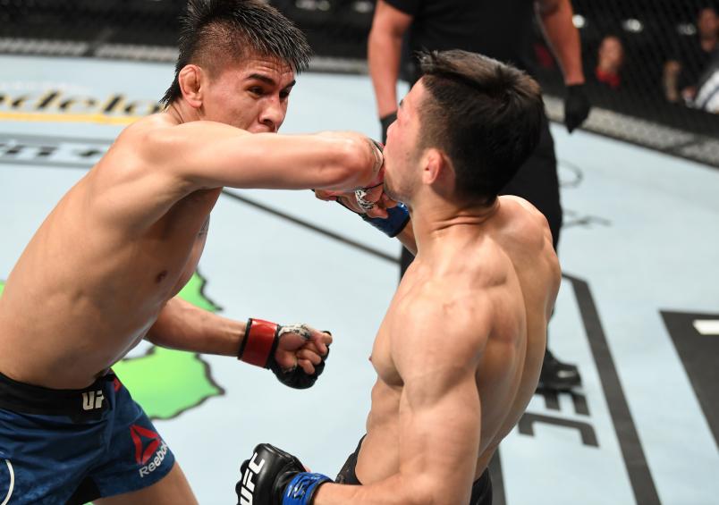 SAN ANTONIO, TEXAS - JULY 20: (L-R) Mario Bautista elbows Jin Soo Son in their bantamweight bout during the UFC Fight Night event at AT&T Center on July 20, 2019 in San Antonio, Texas. (Photo by Josh Hedges/Zuffa LLC)