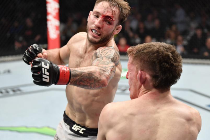 MELBOURNE, AUSTRALIA - OCTOBER 06: (L-R) Brad Riddell of New Zealand punches Jamie Mullarkey of Australia in their lightweight fight during the UFC 243 event at Marvel Stadium on October 06, 2019 in Melbourne, Australia. (Photo by Jeff Bottari/Zuffa LLC/Zuffa LLC via Getty Images)