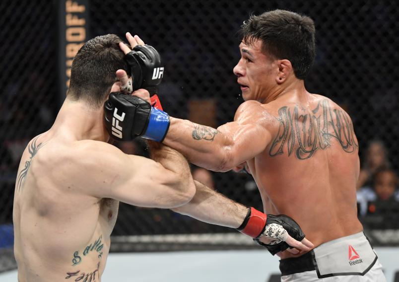 MELBOURNE, AUSTRALIA - OCTOBER 06: (R-L) Maki Pitolo punches Callan Potter of Australia in their welterweight fight during the UFC 243 event at Marvel Stadium on October 06, 2019 in Melbourne, Australia. (Photo by Jeff Bottari/Zuffa LLC/Zuffa LLC via Getty Images)