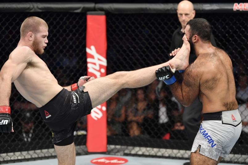 MELBOURNE, AUSTRALIA - OCTOBER 06: (L-R) Jake Matthews of Australia kicks Rostem Akman of Sweden in their welterweight fight during the UFC 243 event at Marvel Stadium on October 06, 2019 in Melbourne, Australia. (Photo by Jeff Bottari/Zuffa LLC/Zuffa LLC via Getty Images)