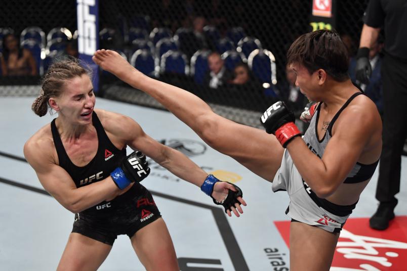 SINGAPORE, SINGAPORE - OCTOBER 26: (R-L) Loma Lookboonmee of Thailand kicks Alexandra Albu of Moldova in their women's strawweight bout during the UFC Fight Night event at Singapore Indoor Stadium on October 26, 2019 in Singapore. (Photo by Jeff Bottari/Zuffa LLC via Getty Images)