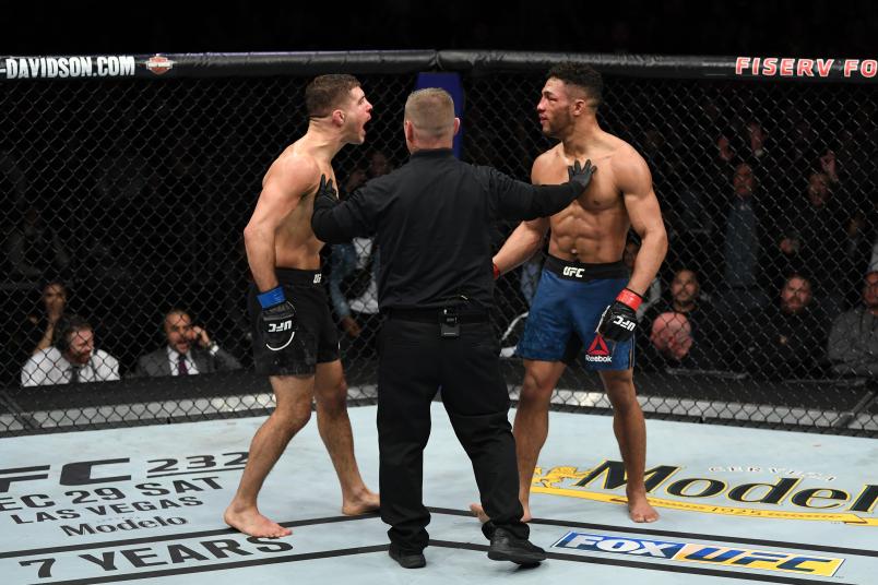 Al Iaquinta and Kevin Lee react after the conclusion of their lightweight bout during the UFC Fight Night event at Fiserv Forum on December 15, 2018 in Milwaukee, Wisconsin. (Photo by Jeff Bottari/Zuffa LLC via Getty Images)