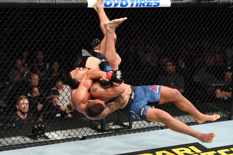 ANAHEIM, CALIFORNIA - AUGUST 17: (R-L) Drakkar Klose slams Christos Giagos in their lightweight bout during the UFC 241 event at the Honda Center on August 17, 2019 in Anaheim, California. (Photo by Josh Hedges/Zuffa LLC/Zuffa LLC via Getty Images)