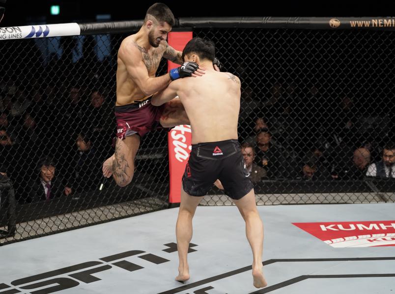 BUSAN, SOUTH KOREA - DECEMBER 21: (L-R) Charles Jourdain of Canada lands a flying knee against Dooho Choi of South Korea in their featherweight fight during the UFC Fight Night event at Sajik Arena 3 on December 21, 2019 in Busan, South Korea. (Photo by Jeff Bottari/Zuffa LLC via Getty Images)
