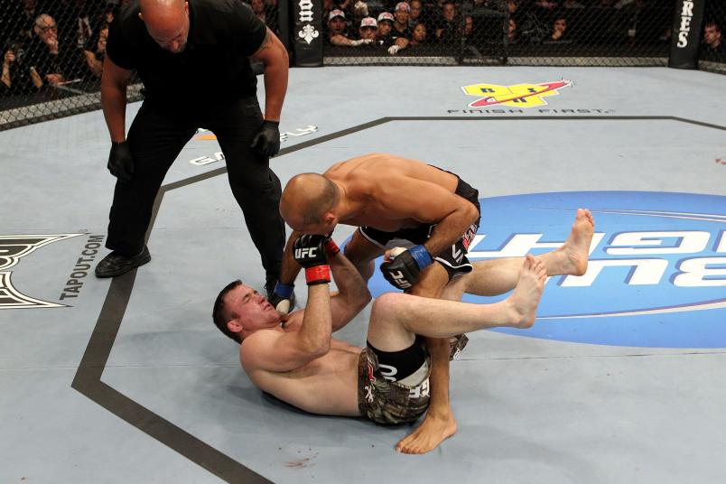 AUBURN HILLAS, MI - NOVEMBER 20: BJ Penn (standing) lands a punch to the face against Matt Hughes (red gloves) during their Welterweight bout part of UFC 123 at the Palace of Auburn Hills on November 20, 2010 in Auburn Hills, Michigan. (Photo by Josh Hedges/Zuffa LLC/Zuffa LLC via Getty Images)