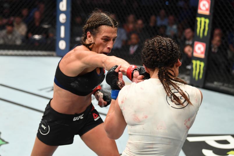 TAMPA, FLORIDA - OCTOBER 12: (L-R) Joanna Jedrzejczyk of Poland punches Michelle Waterson in their women's strawweight bout during the UFC Fight Night event at Amalie Arena on October 12, 2019 in Tampa, Florida. (Photo by Josh Hedges/Zuffa LLC)
