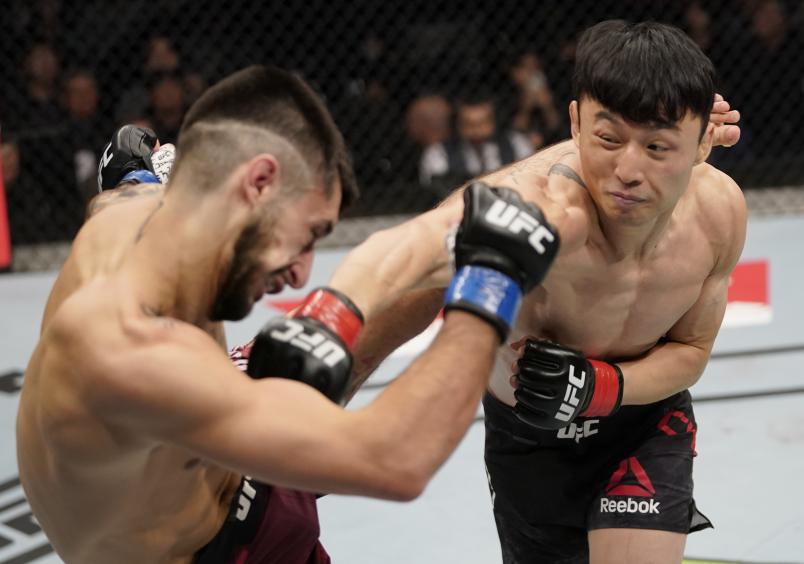 BUSAN, SOUTH KOREA - DECEMBER 21: (R-L) Dooho Choi of South Korea punches Charles Jourdain of Canada in their featherweight fight during the UFC Fight Night event at Sajik Arena 3 on December 21, 2019 in South Korea. (Photo by Jeff Bottari/Zuffa LLC)