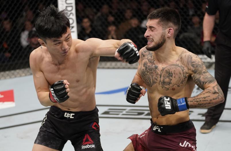 BUSAN, SOUTH KOREA - DECEMBER 21: (L-R) Dooho Choi of South Korea punches Charles Jourdain of Canada in their featherweight fight during the UFC Fight Night event at Sajik Arena 3 on December 21, 2019 in Busan, South Korea. (Photo by Jeff Bottari/Zuffa LLC)