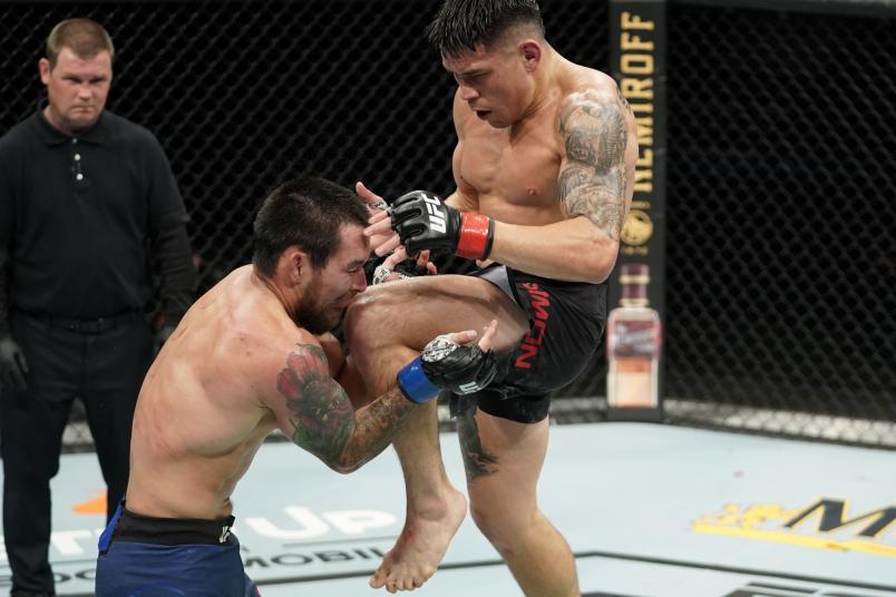 JACKSONVILLE, FLORIDA - MAY 13: (R-L) Ricky Simon knees Ray Borg in their bantamweight bout during the UFC Fight Night Event at VyStar Veterans Memorial Arena on May 13, 2020 in Jacksonville, Florida. (Photo by Cooper Neill/Zuffa LLC)