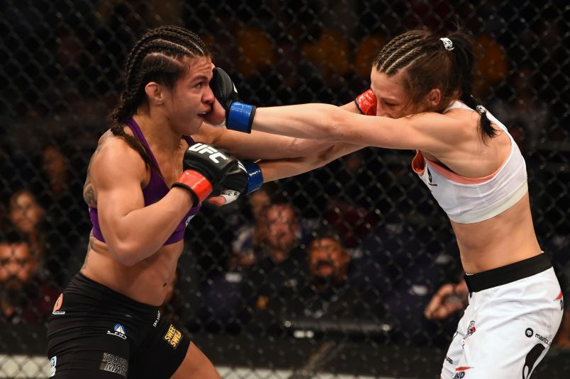 PHOENIX, AZ - DECEMBER 13: (L-R) Claudia Gadelha of Brazil and Joanna Jedrzejczyk of Poland exchange punches in their women's strawweight fight during the UFC Fight Night event at the U.S. Airways Center on December 13, 2014 in Phoenix, Arizona. (Photo by Josh Hedges/Zuffa LLC/Zuffa LLC via Getty Images)